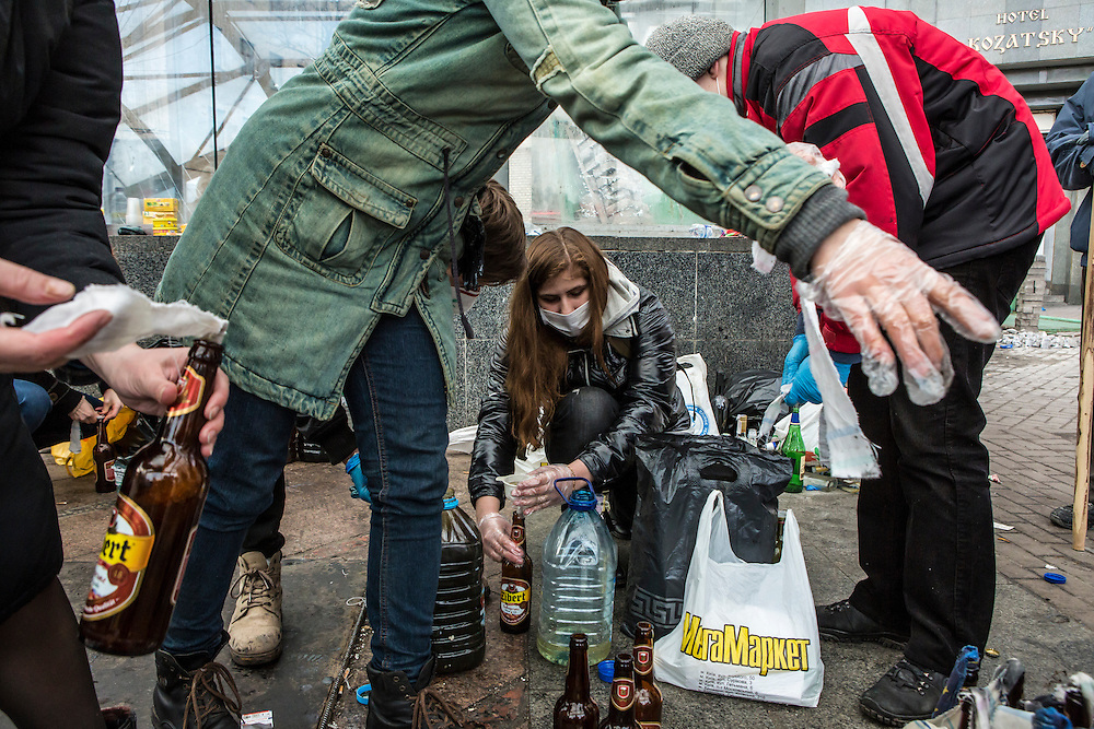 KIEV, UKRAINE - FEBRUARY 20: Women prepare Molotov cocktails for anti-government protesters near Independence Square on February 20, 2014 in Kiev, Ukraine. After several weeks of calm, violence has again flared between anti-government protesters and police, with dozens killed. (Photo by Brendan Hoffman/Getty Images) *** Local Caption ***